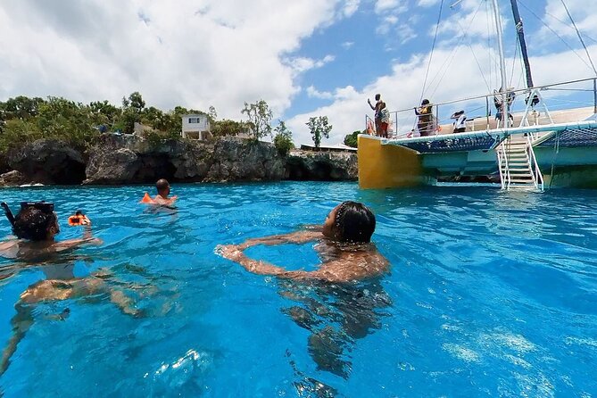 Party Catamaran Sunset Ricks Cafe Negril Open Bar and DJ - A lively Jamaica party cruise combining snorkeling, cliff jumping, and sunset fun
